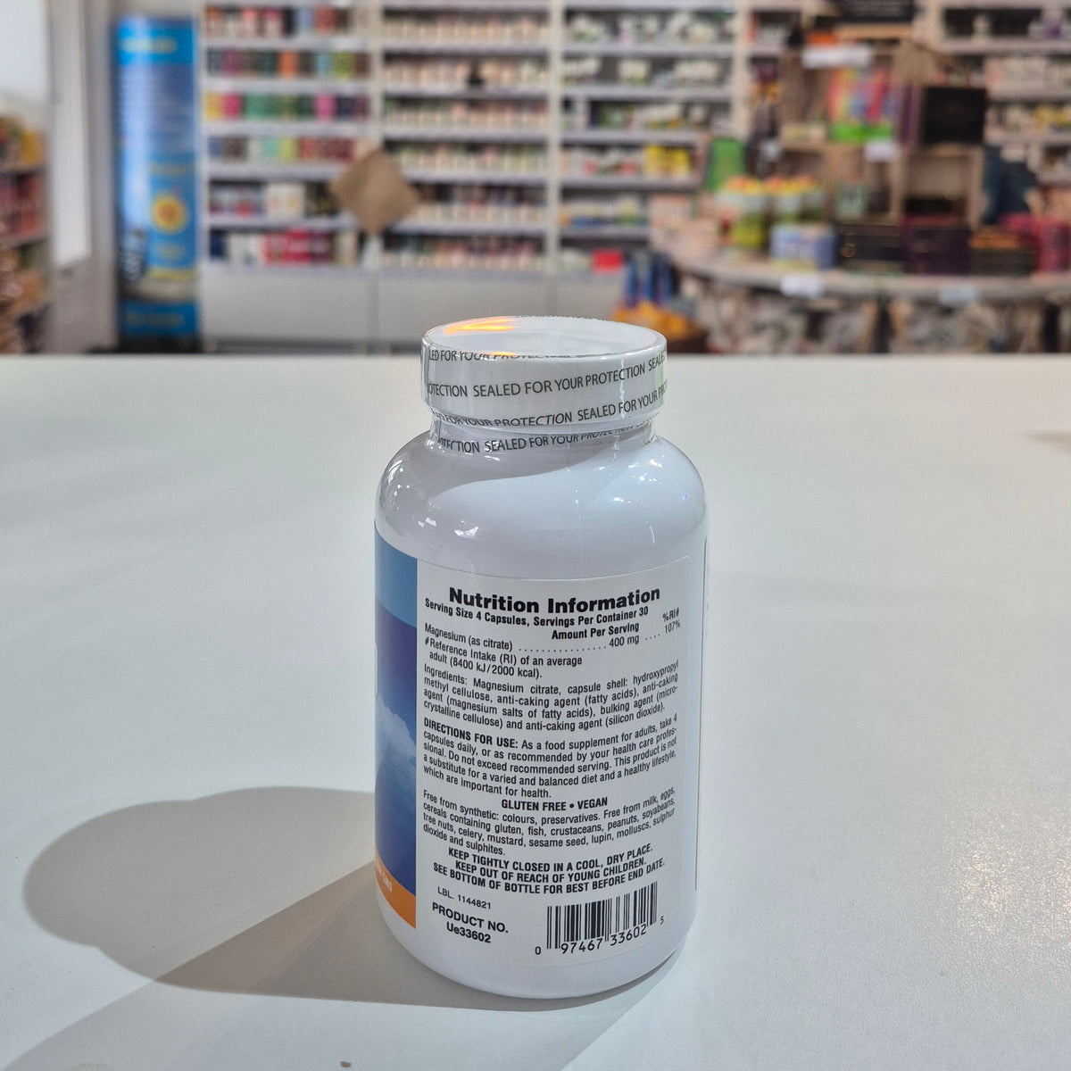 White bottle with label in front of a blurred store interior
