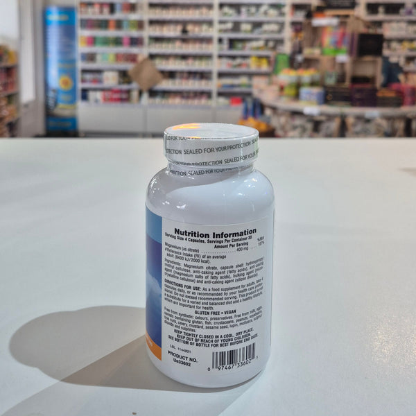 White bottle with label in front of a blurred store interior