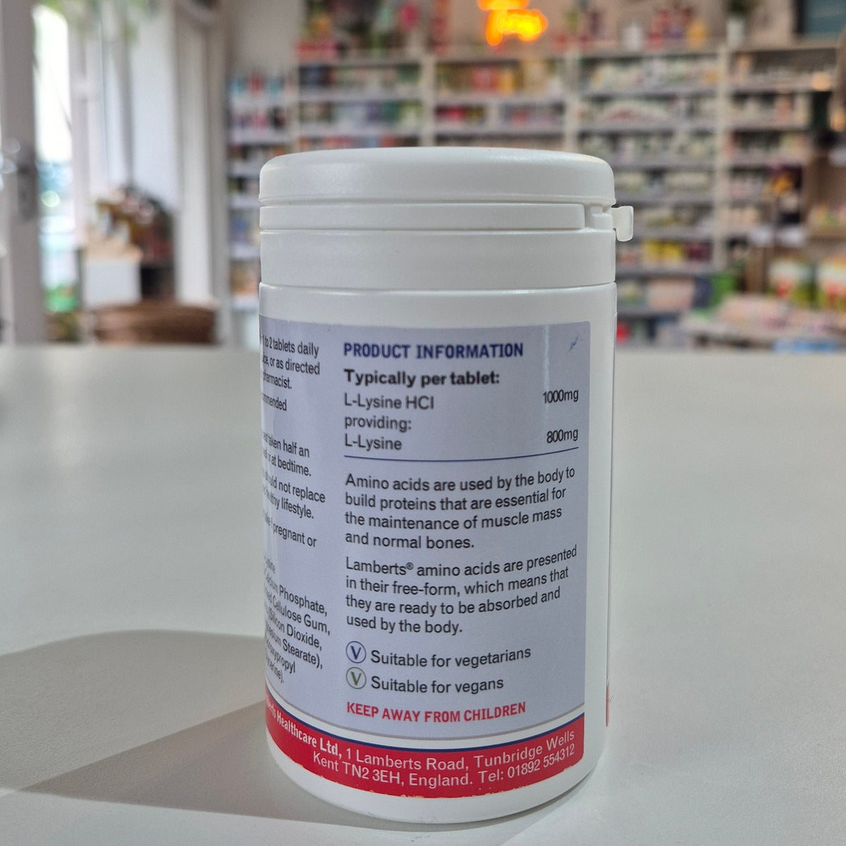 Close-up of a bottle with a label in an indoor setting, possibly a store.