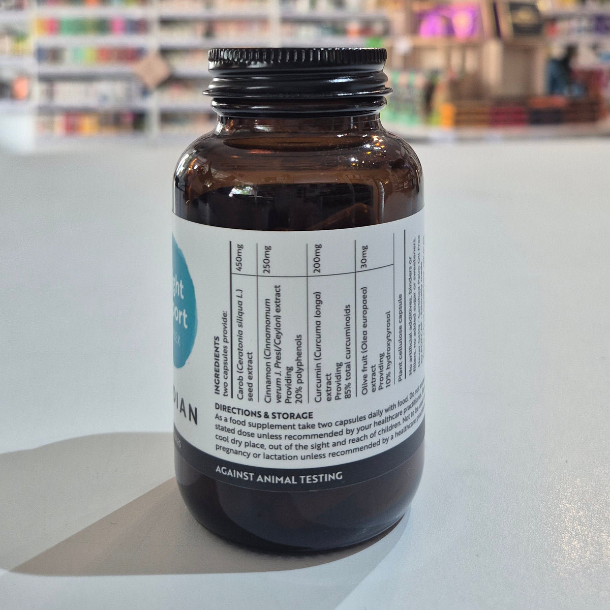 Brown supplement bottle with label on a white surface