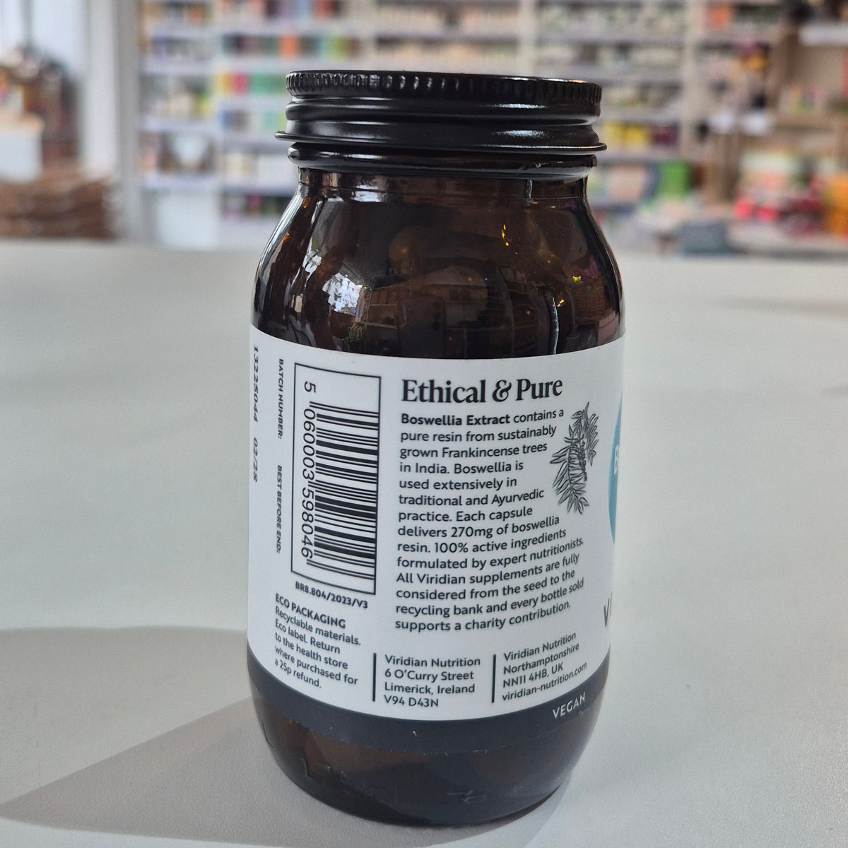 Bottle of Boswellia extract by Viridian on a white surface with a blurred background