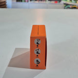 Orange box with instructions on a gray surface