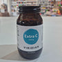 Brown supplement bottle labeled 'Extra C 550mg' by Viridian on a white surface with a blurred store background.