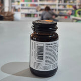 Bottle with a label on a white surface, blurred background