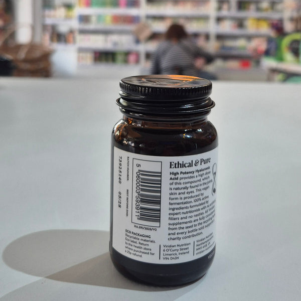 Bottle with a label on a white surface, blurred background