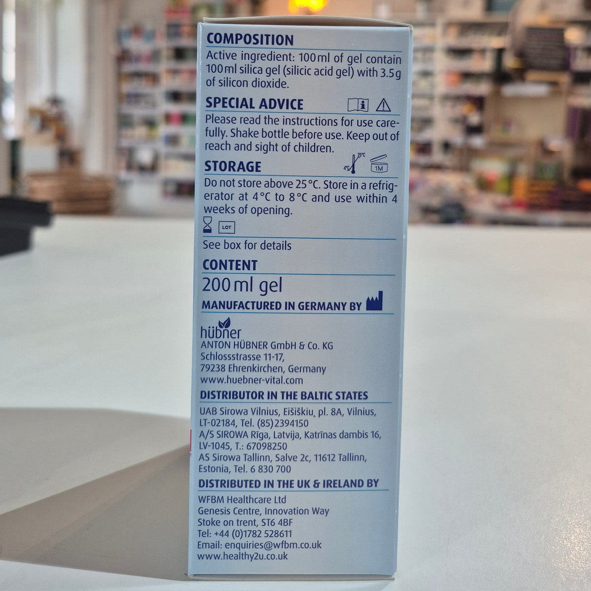 Packaging of Hubner Original Silicea Gi Gel 200Ml for gastro-intestinal complaints, displaying indications such as nausea, vomiting, flatulence, diarrhoea, stomach aches, and heartburn in a shop, on a counter side of the packet