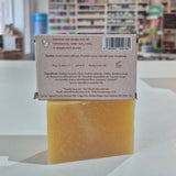 Bar of soap with a box in front of a blurred store interior
