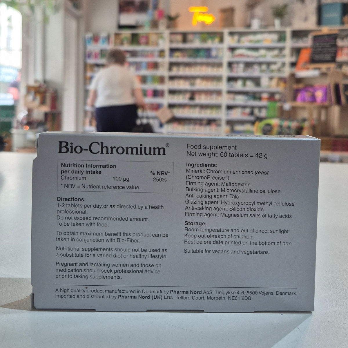 Product packaging with text on a blurred background of shelves and lights
