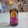 Can of Agua de Madre pepper on a white surface with a blurred store interior in the background.
