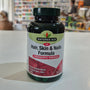 Natures Aid Hair, Skin & Nails Formula bottle on a counter with a blurred store background