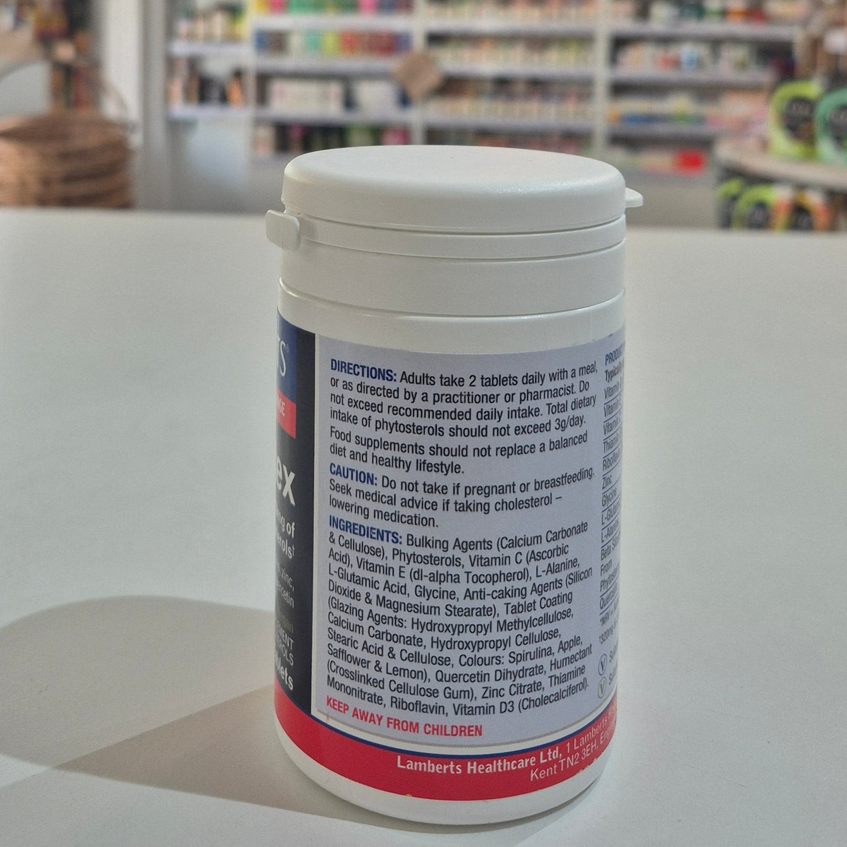 Supplement container with label on a table in a store setting