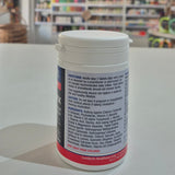 Supplement container with label on a table in a store setting