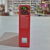 Red box with text and New Nordic logo on a white surface with blurred shelves in the background