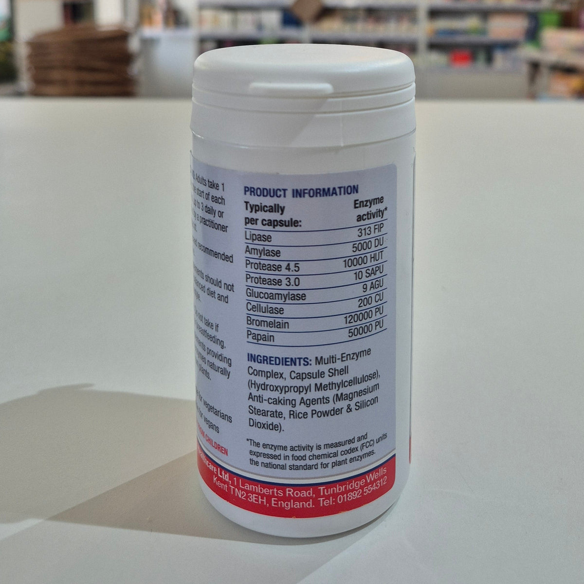 White supplement container with label on a light surface