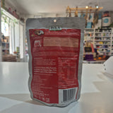 The back of a D.J & A Mushroom pouch, showing the ingredients, nutrition facts, and barcode, placed on a white counter in a store.