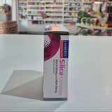 Box of Lambert's Silica Complete supplement on a table with a store shelf in the background