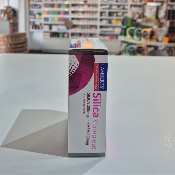 Box of Lambert's Silica Complete supplement on a table with a store shelf in the background