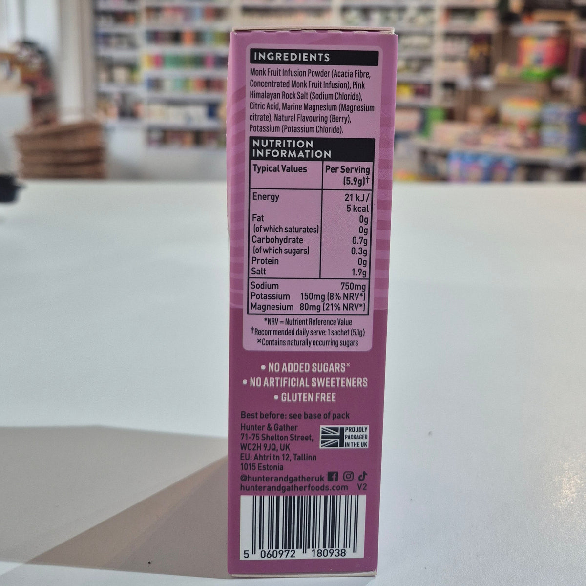 Close-up of a purple product label with a blurred store interior in the background