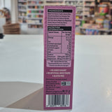Close-up of a purple product label with a blurred store interior in the background