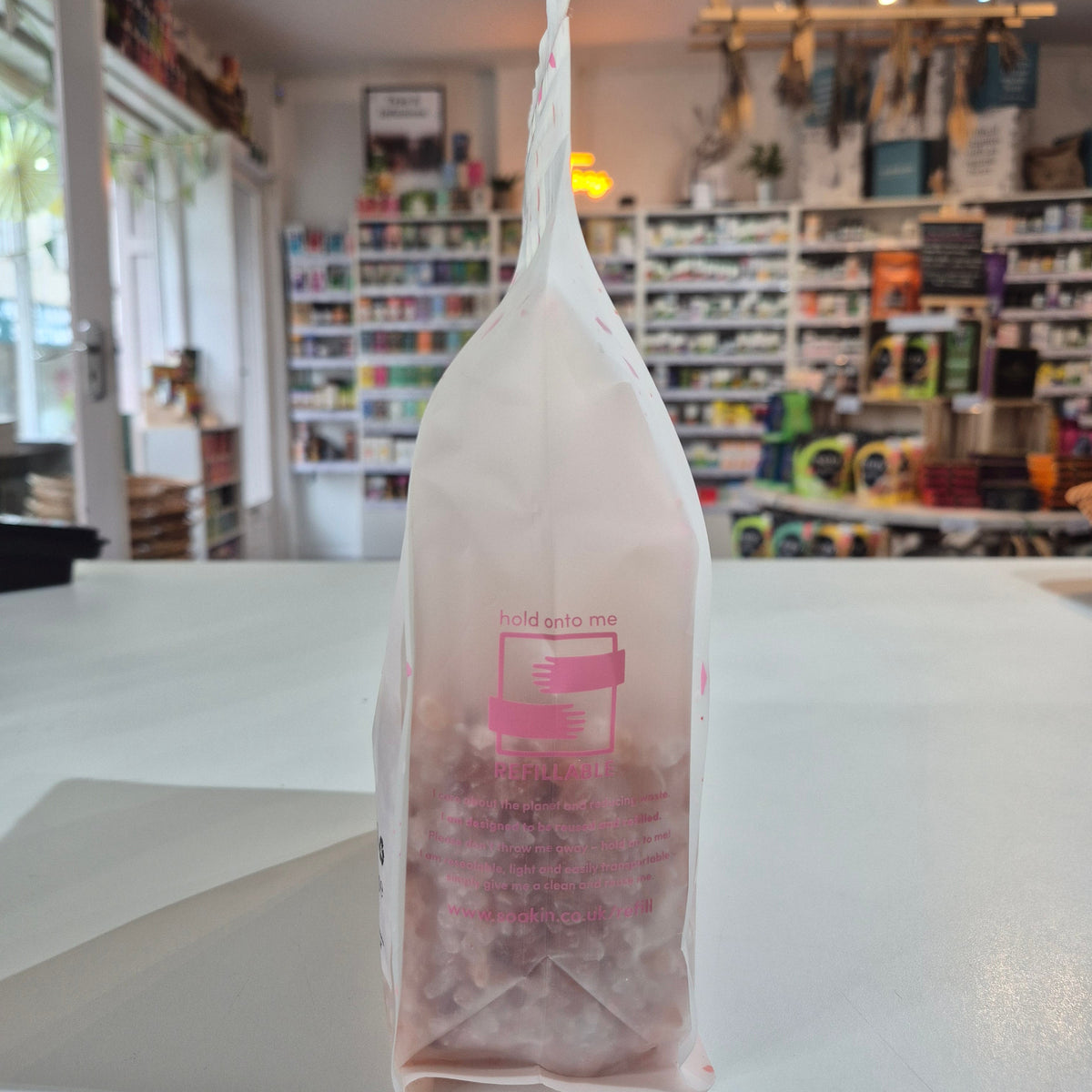 Plastic bag with text and graphics on a counter in a store setting