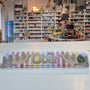 Chocolate bar with a colourful surfboard design and various items on shelves.