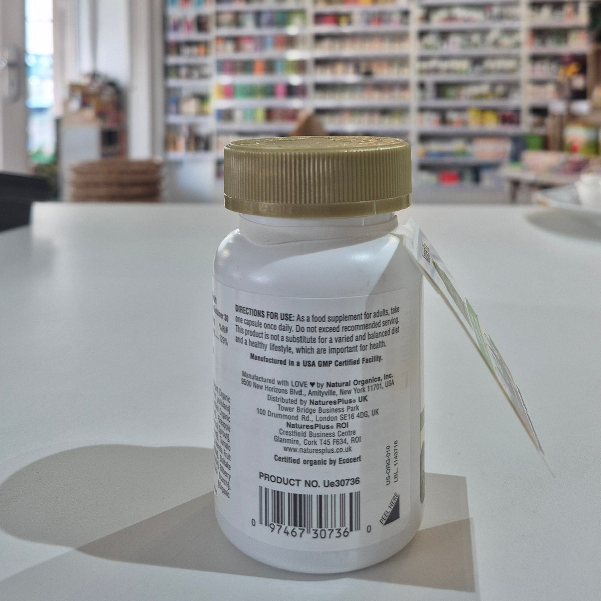 Close-up of a bottle with a blurred indoor setting in the background