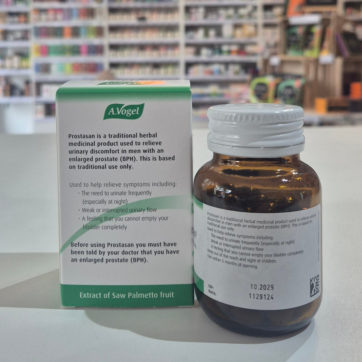 Bottle and box of A.Vogel Prostasan on a counter with a store background