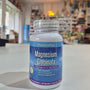 Bottle of NaturesPlus Magnesium Glycinate on a counter with a store background