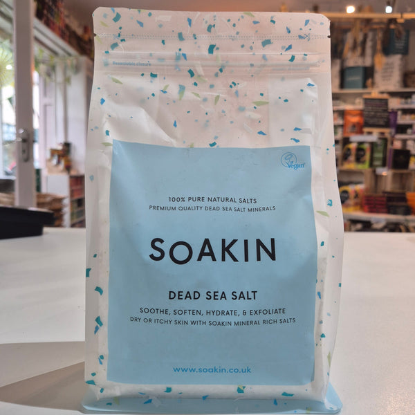 Bag of Soakin Dead Sea Salt with a store interior in the background