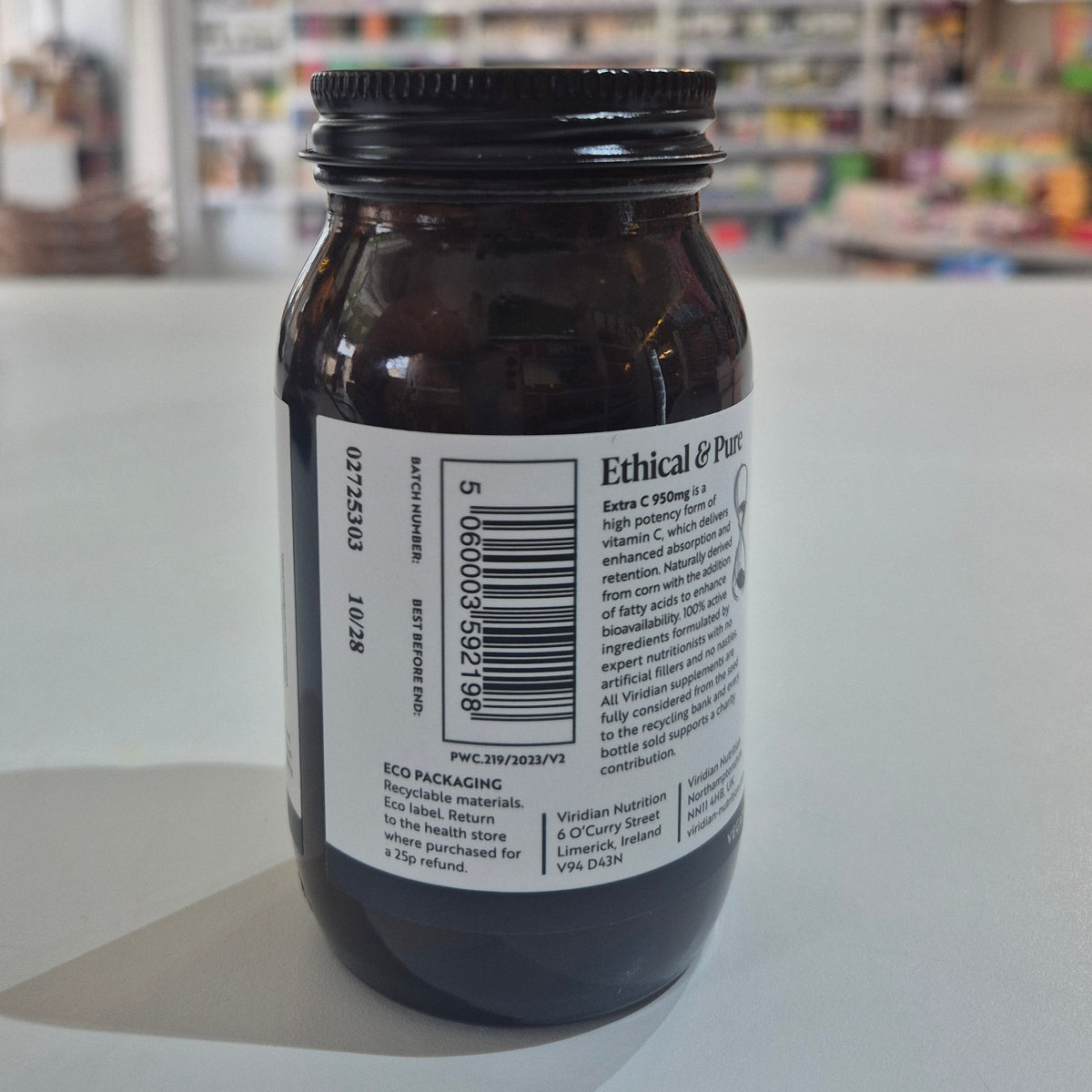 Bottle of Viridian Extra C supplement on a white surface with a blurred background