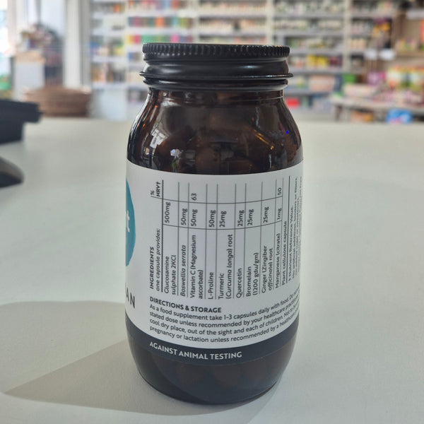 Brown supplement bottle with label on a blurred store background