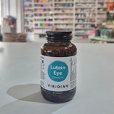Bottle of Viridian Lutein Eye Complex on a counter with a blurred store background