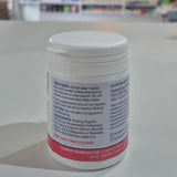 Lamberts Vitamin B12 supplement container on a table with a blurred background. Vitamin supplement container with label on a neutral background