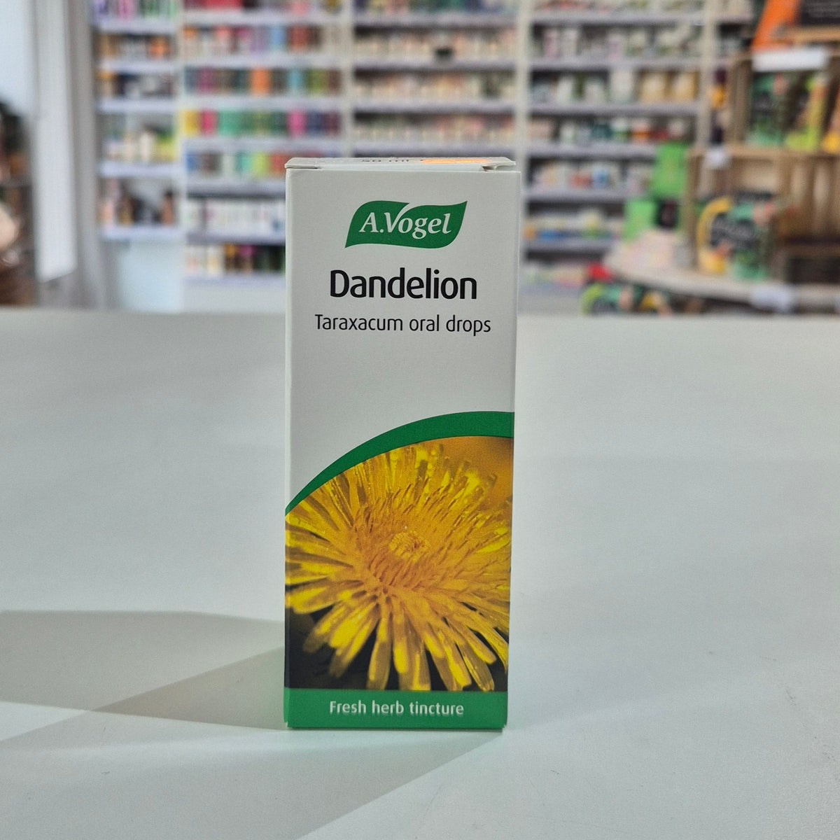 A box of A.Vogel Dandelion Taraxacum oral drops on a surface with a blurred store background.