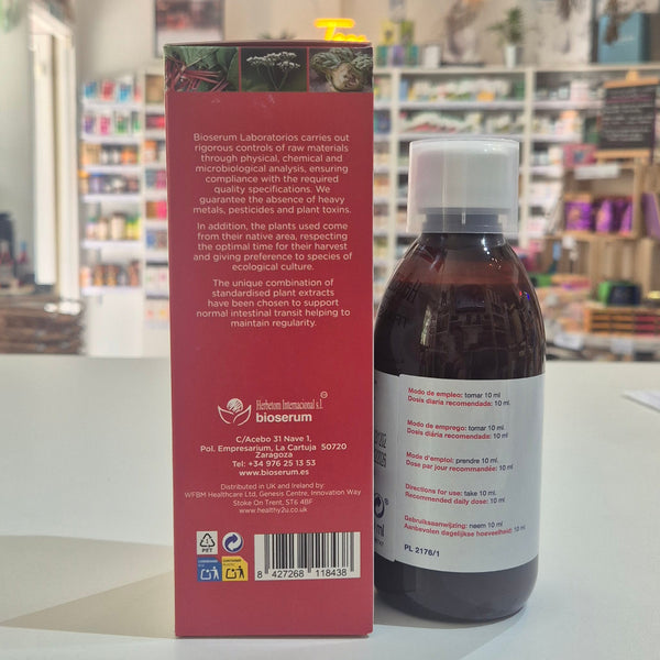 A bottle of Bioserum Herbetom and its matching pink packaging box, displayed on a white counter in a retail store setting.