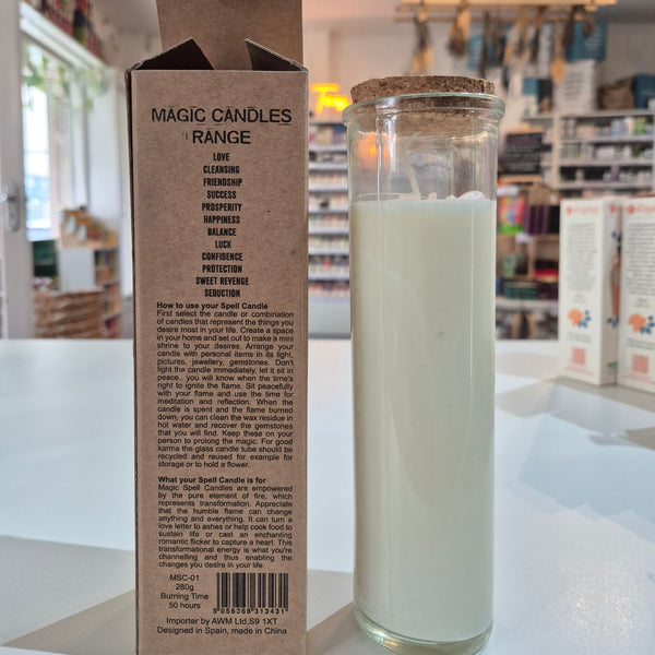 Glass candle with a cardboard box displaying text and a barcode on a white surface.