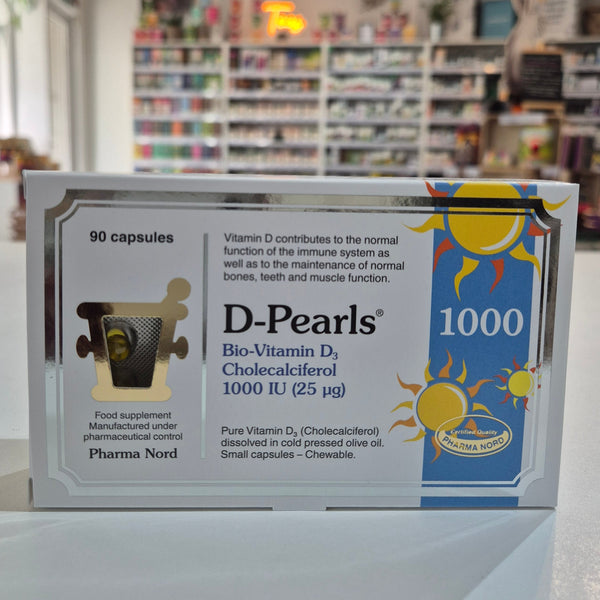 Box of D-Pearls 1000 capsules with a blurred bookstore background