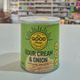 Can of 'Sour Cream & Onion' potato crisps from The Good Crisp Company on a white surface with a blurred store background.