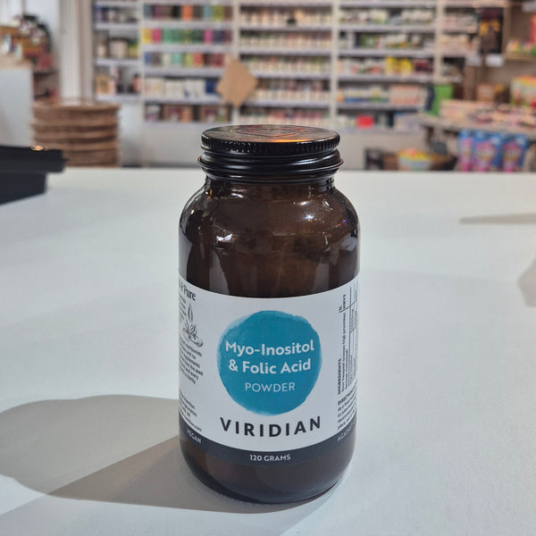 Myo-Inositol & Folic supplement bottle with Viridian label on a white surface, with  blurred store interior in the background