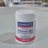 Lamberts Vitamin B12 supplement container on a table with a blurred background