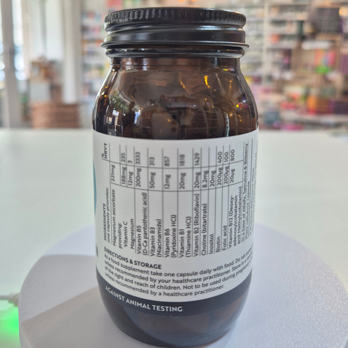 Jar of Viridian High B5 Complex supplement on a white surface with a blurred background. Brown supplement bottle with label on a white surface