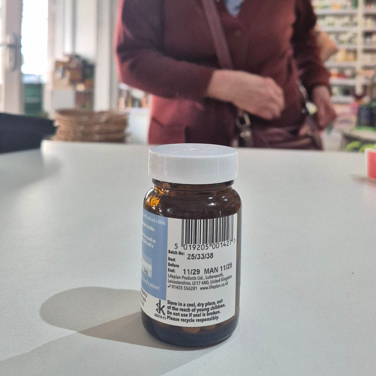 Bottle with a label on a table in a store setting