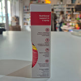Vitamin C spray packaging on a counter with a blurred store background
