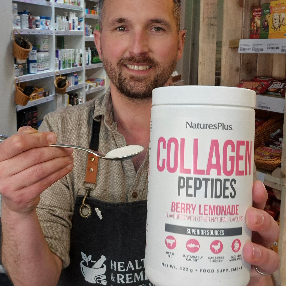 Man holding a container of NaturesPlus Collagen Peptides in a store setting