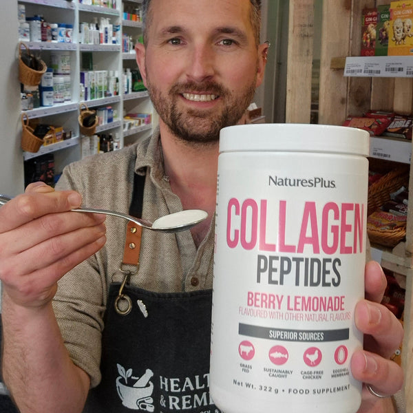 Man holding a container of NaturesPlus Collagen Peptides in a store setting