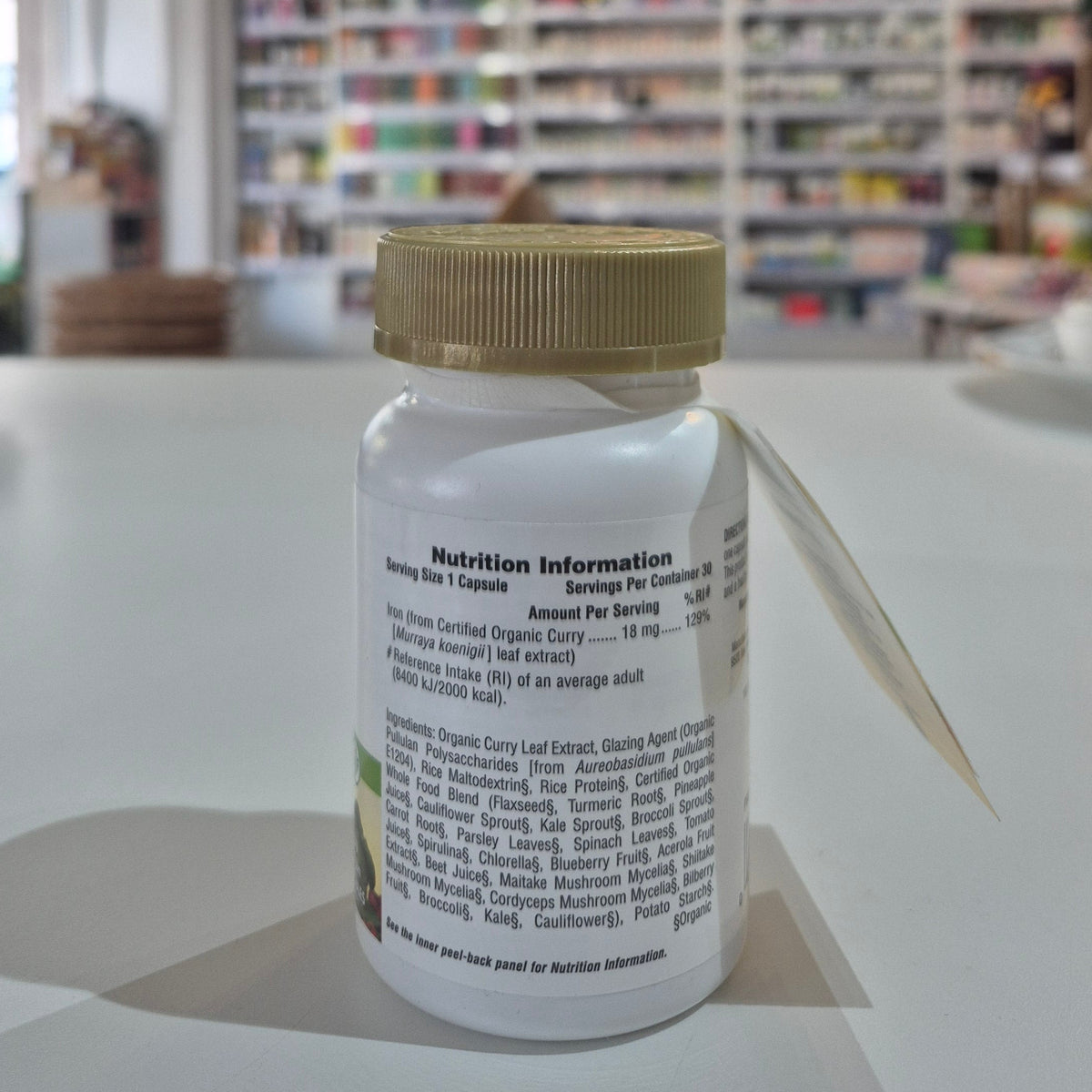 Close-up of a bottle with a label in a blurred indoor setting