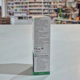 Eyedrop container with label on a white surface, blurred store background