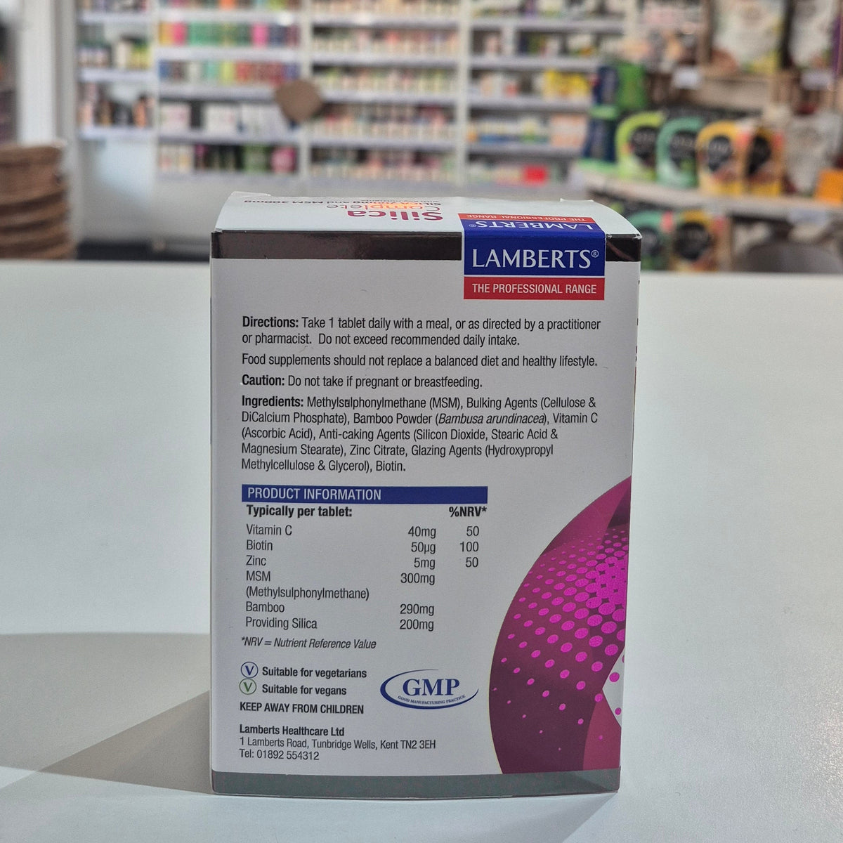 Lamberts supplement box with product information on a blurred store background