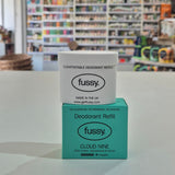 Fussy deodorant refill packaging on a counter with a store shelf in the background
