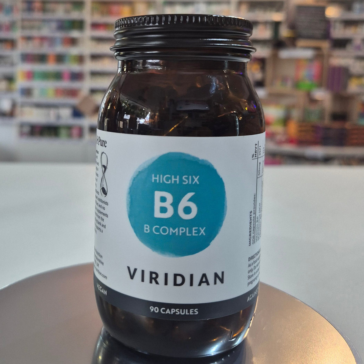 Jar of Viridian High Six B6 B Complex supplement on a counter with a blurred store background